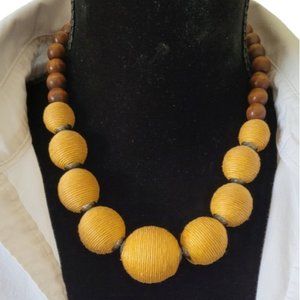 PLUNDER POSSE Womans Chunky threaded beaded & wood necklace. Mustard Adjustable